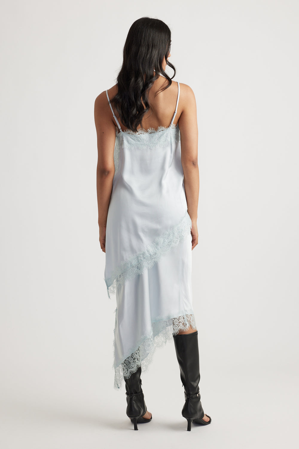 Karla Lace Tunic in pale blue satin with lace trimming and slim straps styled with black boots by DECJUBA Australian fashion brand