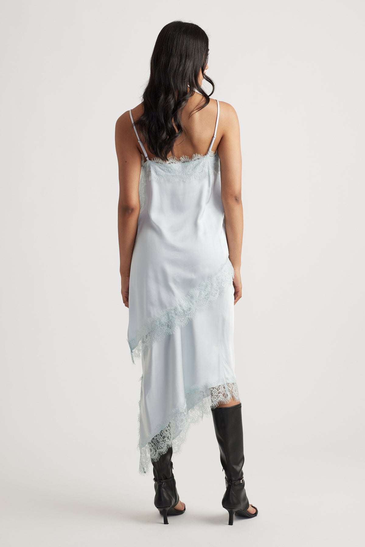 Karla Lace Tunic in pale blue satin with lace trimming and slim straps styled with black boots by DECJUBA Australian fashion brand
