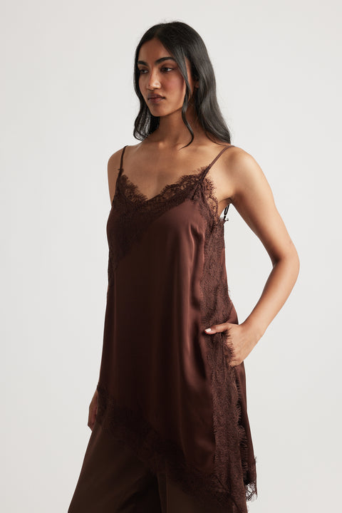 Woman wearing deep brown Karla Lace Tunic with delicate lace detail, designed by DECJUBA Australian fashion brand