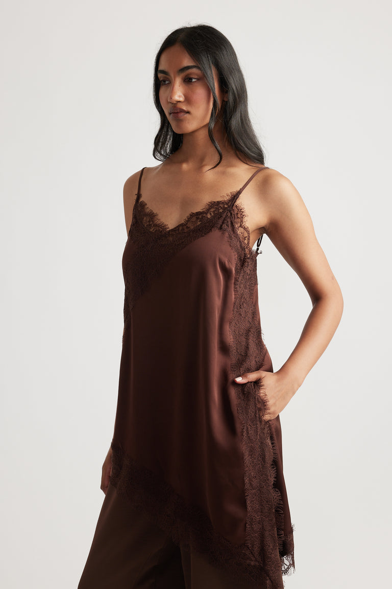 Woman wearing deep brown Karla Lace Tunic with delicate lace detail, designed by DECJUBA Australian fashion brand