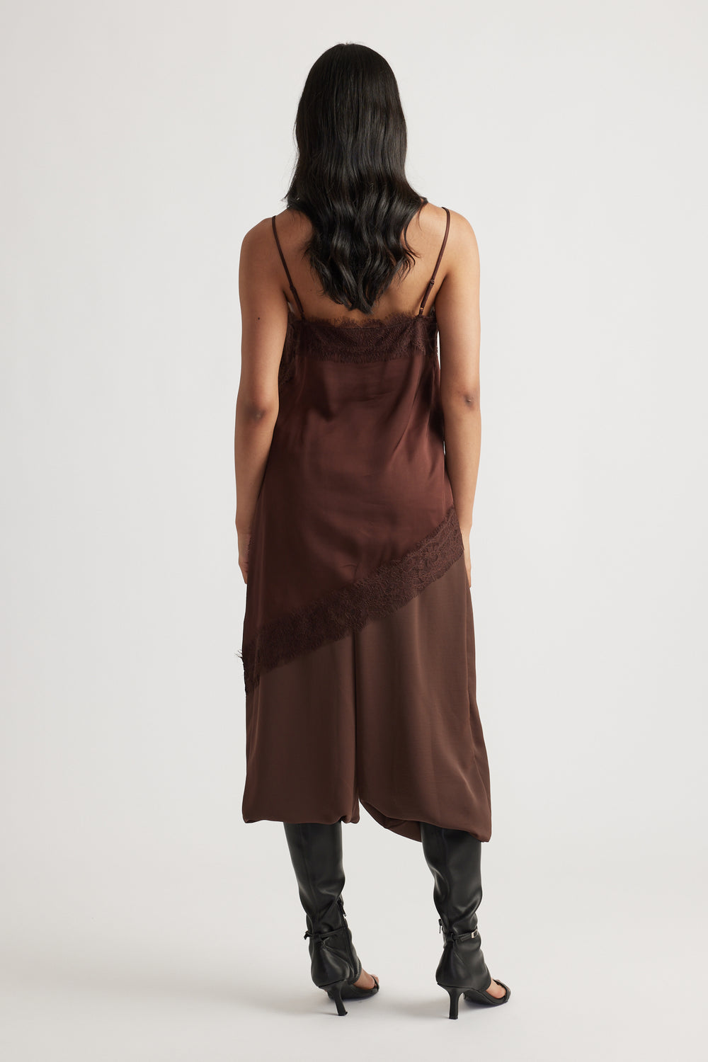 Back view of woman wearing Karla Lace Tunic in rich brown with lace trim, styled with black heeled boots by DECJUBA Australian brand