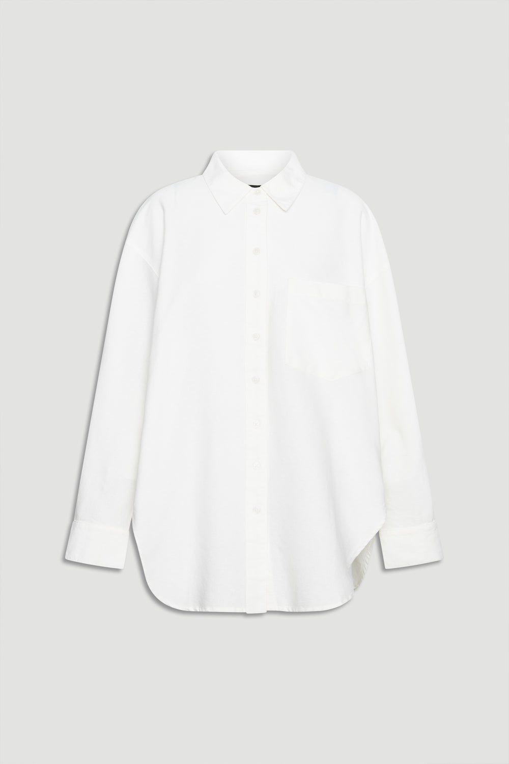 Crisp white oversized shirt with classic collar, button front, chest pocket, and long sleeves for a relaxed look.