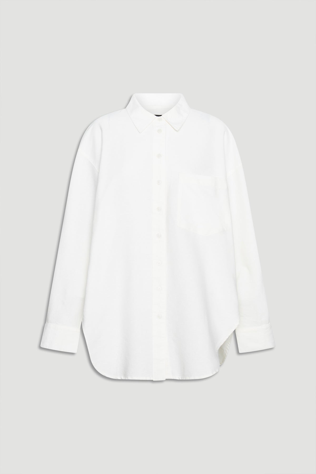 Crisp white oversized shirt with classic collar, button front, chest pocket, and long sleeves for a relaxed look.
