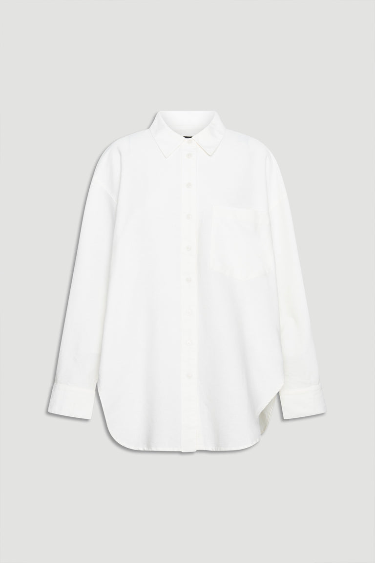 Crisp white oversized shirt with classic collar, button front, chest pocket, and long sleeves for a relaxed look.