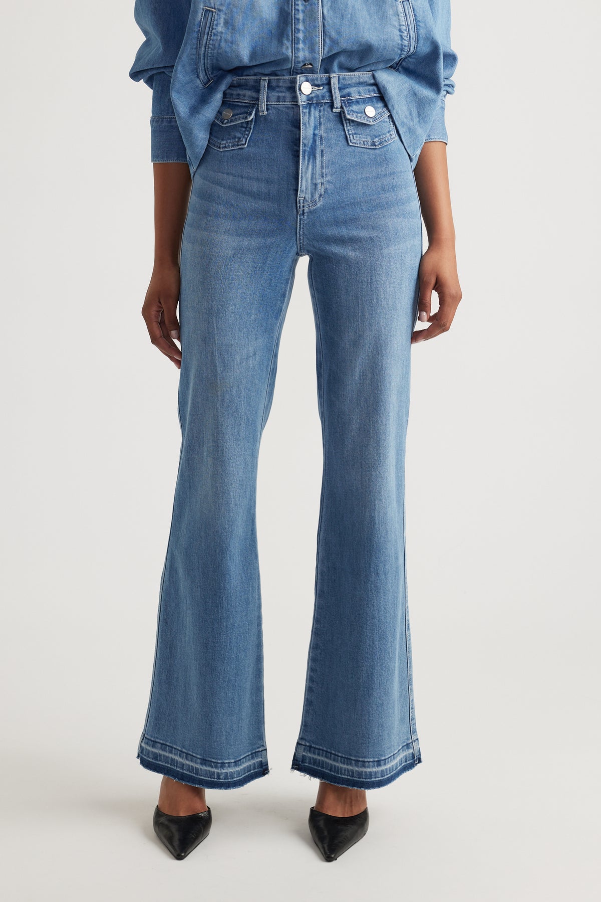 Bea Flare Jean in light blue denim with high waist and flared leg featuring front flap pockets by DECJUBA Australian brand