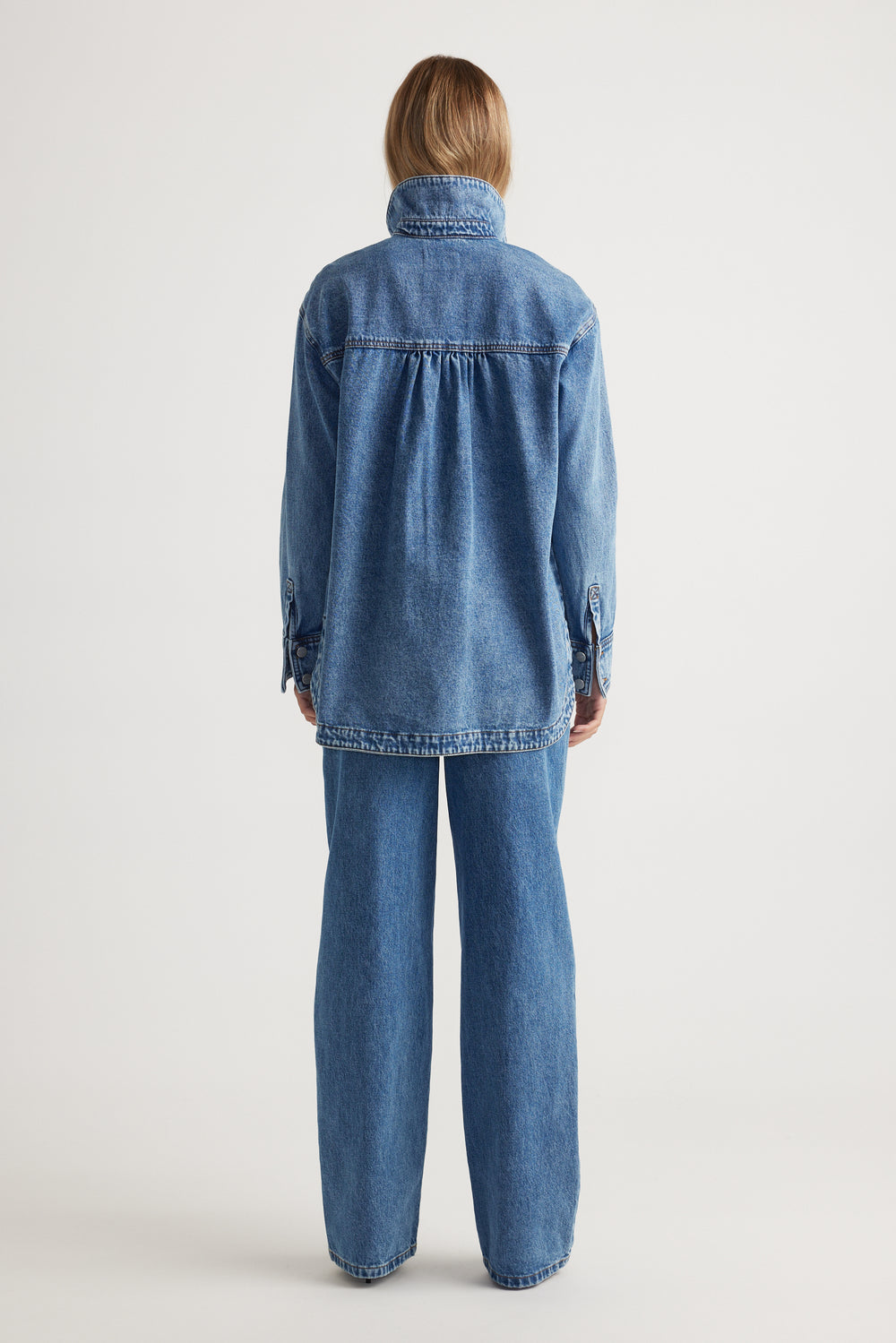 Ariana Denim Shirt in mid-blue wash with relaxed fit and high collar shown from the back by DECJUBA Australian fashion brand