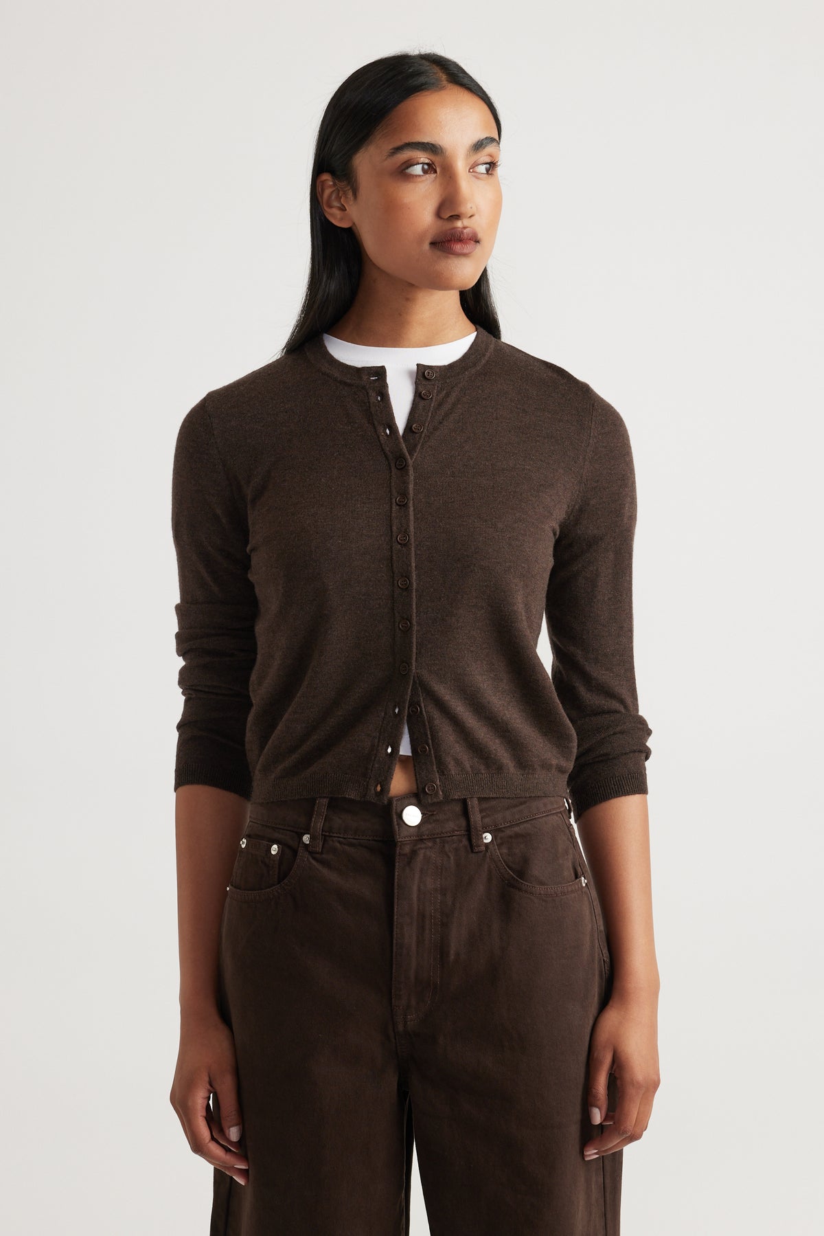 Woman wearing Bella Button Through Cardigan in rich chocolate brown with a round neckline and full-length sleeves by DECJUBA