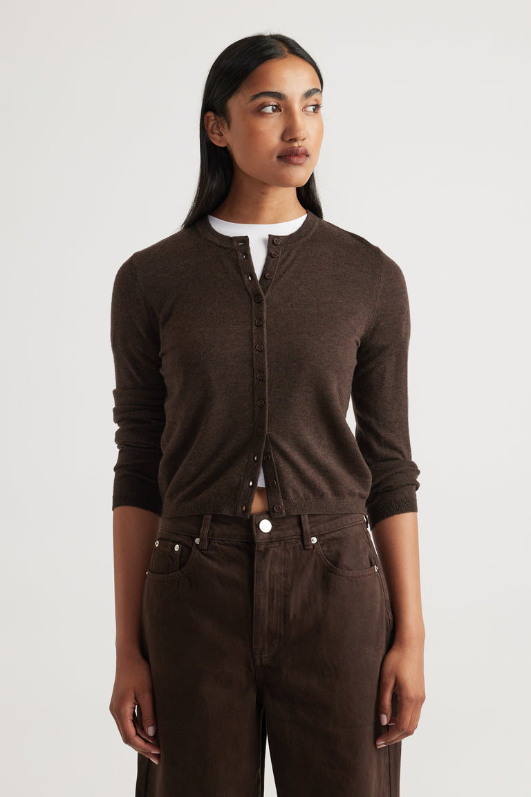 Woman wearing Bella Button Through Cardigan in rich chocolate brown with a round neckline and full-length sleeves by DECJUBA