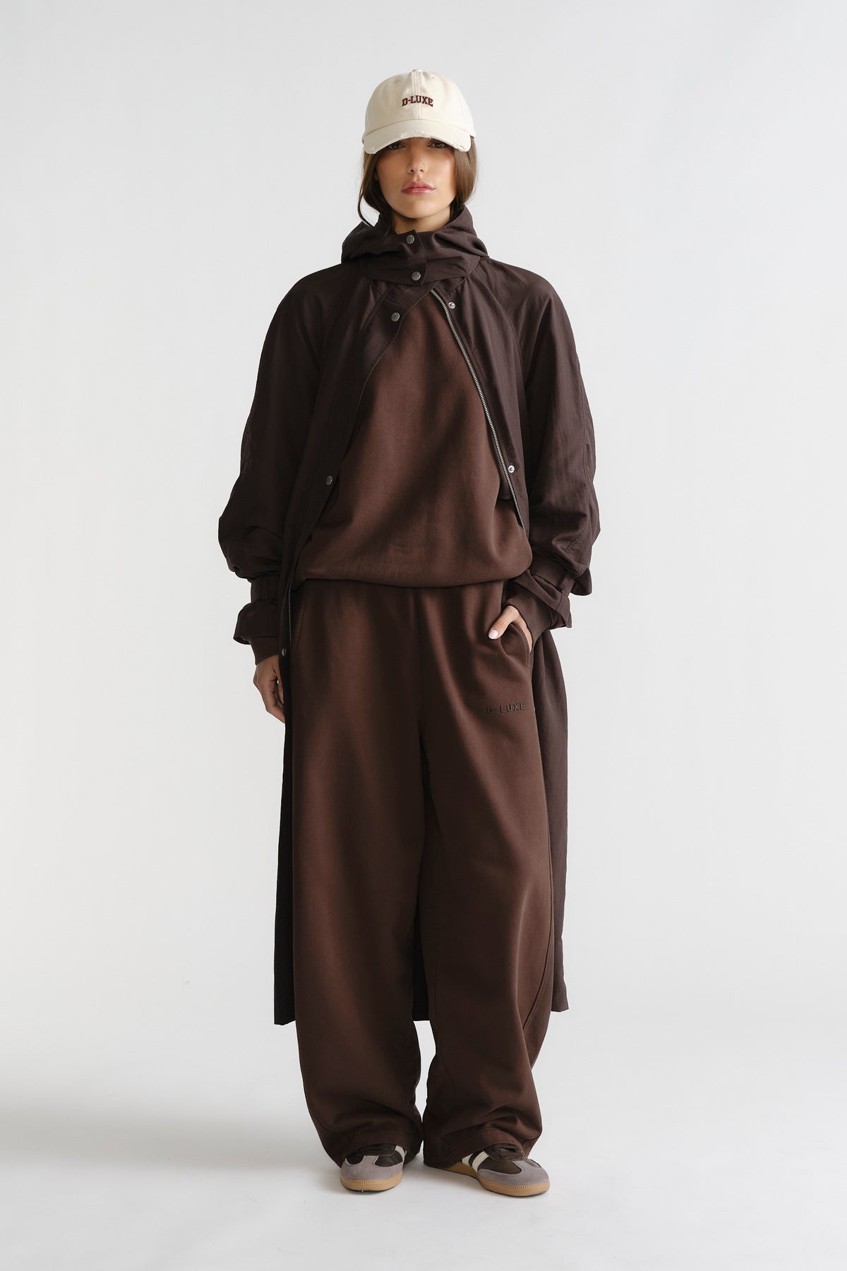 Front view of relaxed fit D-Luxe Washed Trackpant in rich brown paired with layered outerwear and casual sneakers