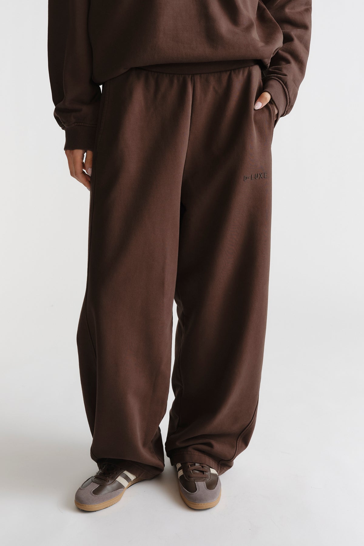 D-Luxe Washed Trackpant in warm walnut brown with relaxed fit, elastic waist, and subtle branded detail by DECJUBA.