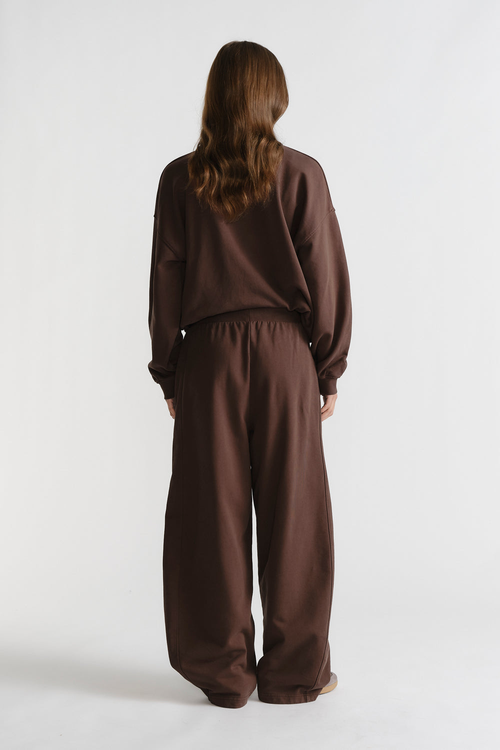 Back view of relaxed fit D-Luxe Washed Trackpant in rich walnut brown with elastic waistband for casual comfort