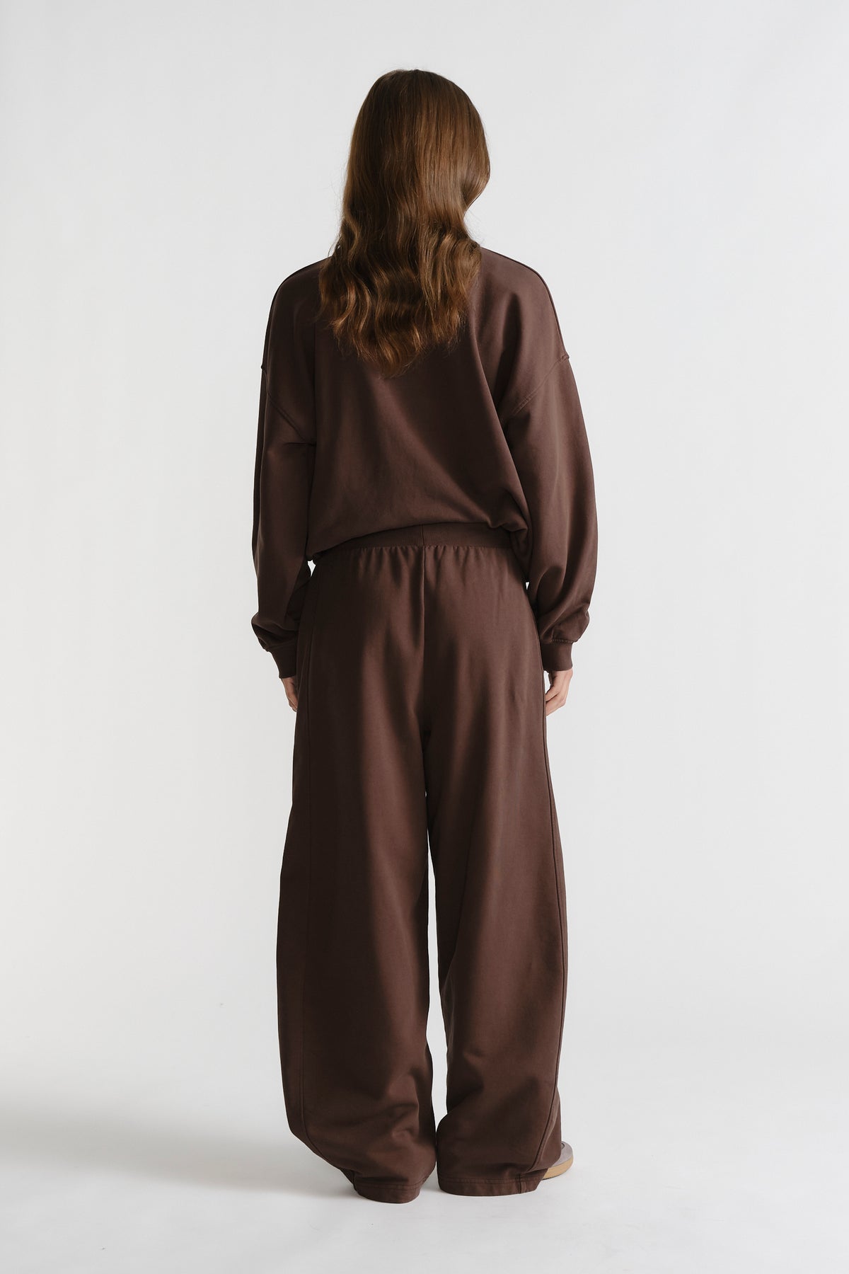 Back view of relaxed fit D-Luxe Washed Trackpant in rich walnut brown with elastic waistband for casual comfort
