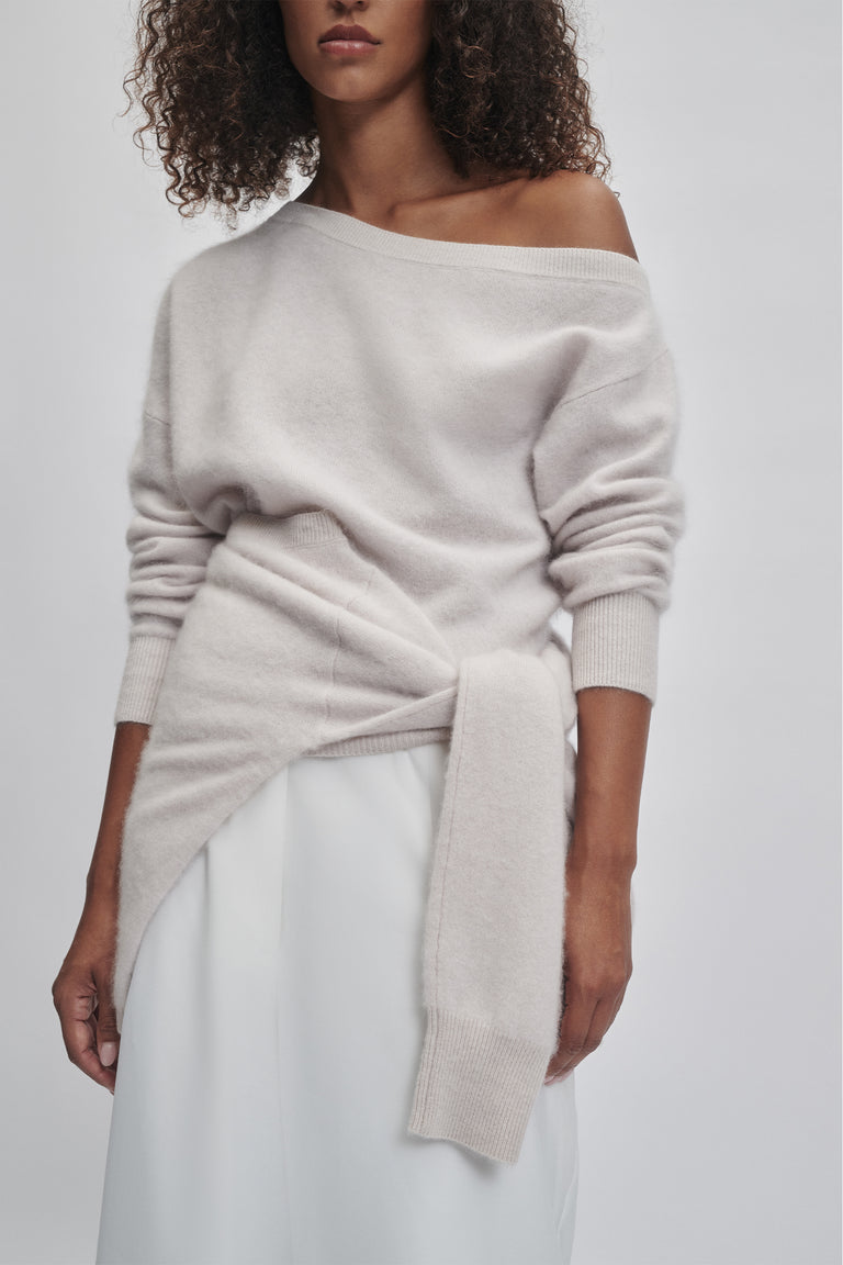 Soft light beige wool jumper with drop shoulder and tied front detail for a relaxed, elegant look