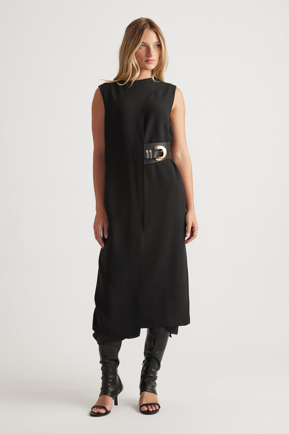Woman wearing Isla Overlay Midi Dress in black sleeveless design with belted waist and asymmetrical hem by DECJUBA