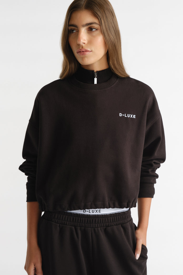 D-Luxe Logo Crop Sweat in black with a relaxed fit, styled with matching bottoms for effortless casual wear by DECJUBA