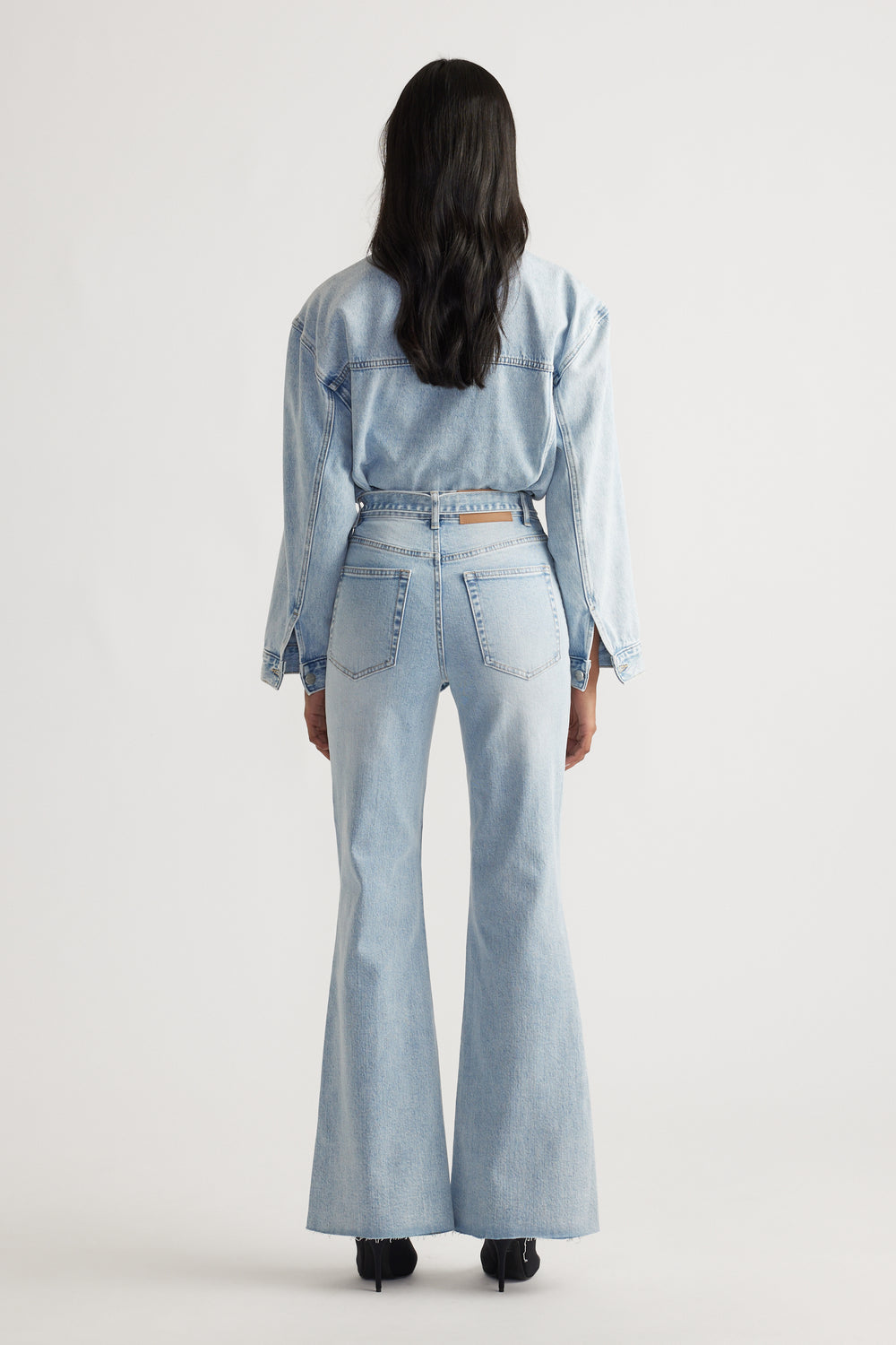 Back view of light hourglass blue Freya Flare Jean styled with a matching denim jacket for a timeless denim look