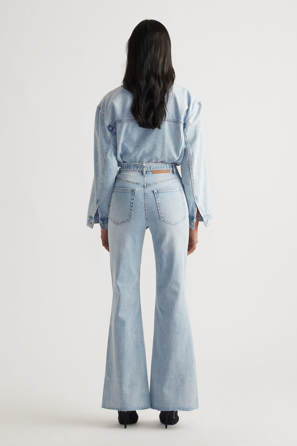 Back view of light hourglass blue Freya Flare Jean styled with a matching denim jacket for a timeless denim look
