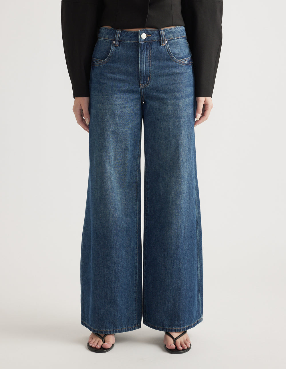 Mid-rise wide leg jeans in classic blue denim with front and back pockets and a relaxed fit silhouette