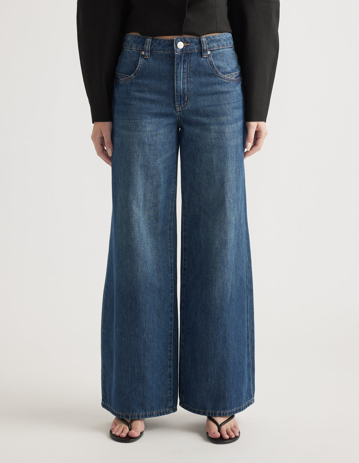 Mid-rise wide leg jeans in classic blue denim with front and back pockets and a relaxed fit silhouette