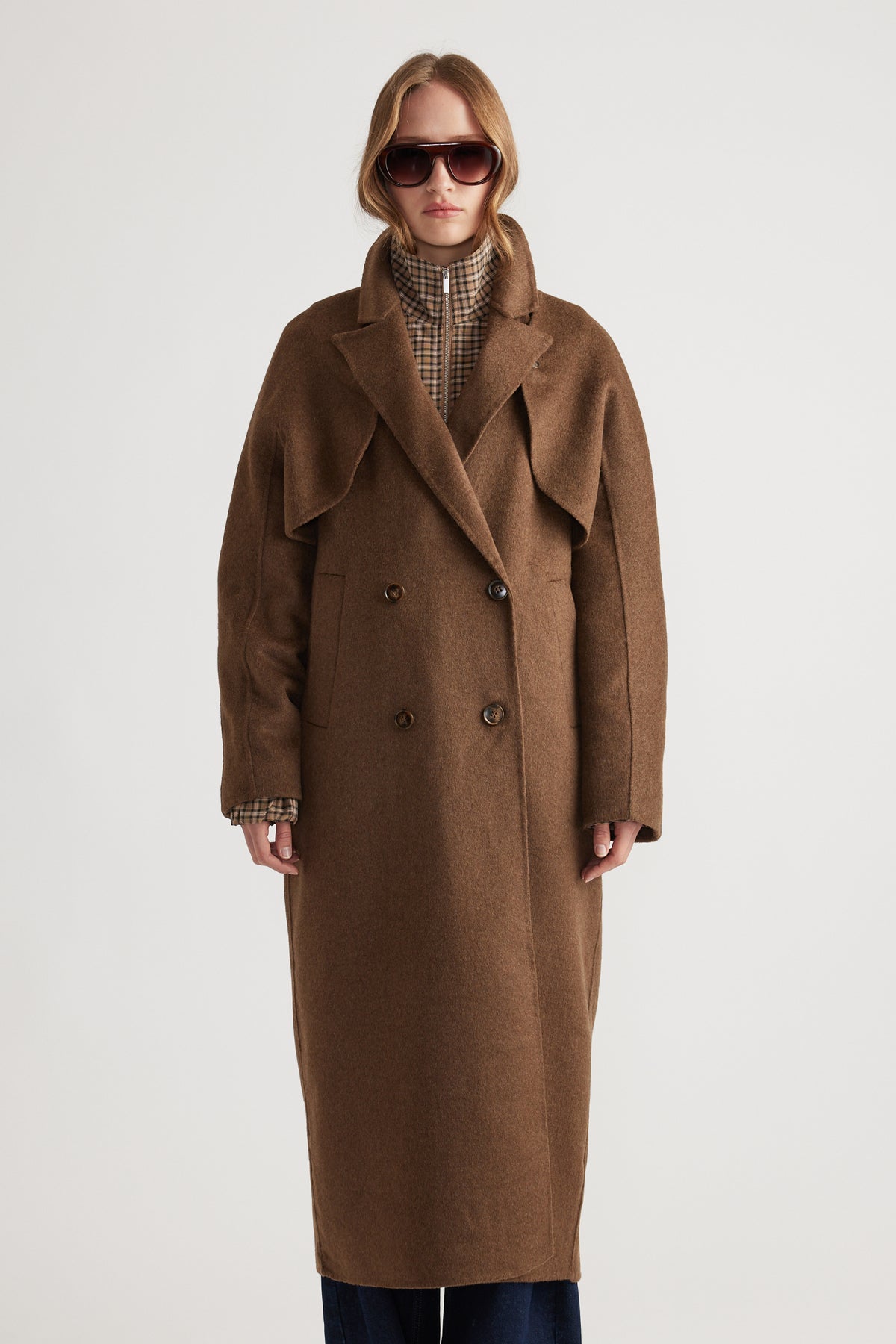 Woman wearing Lucia Felled Two Piece Coat in rich brown with double-breasted buttons and extended lapels for a chic layered look