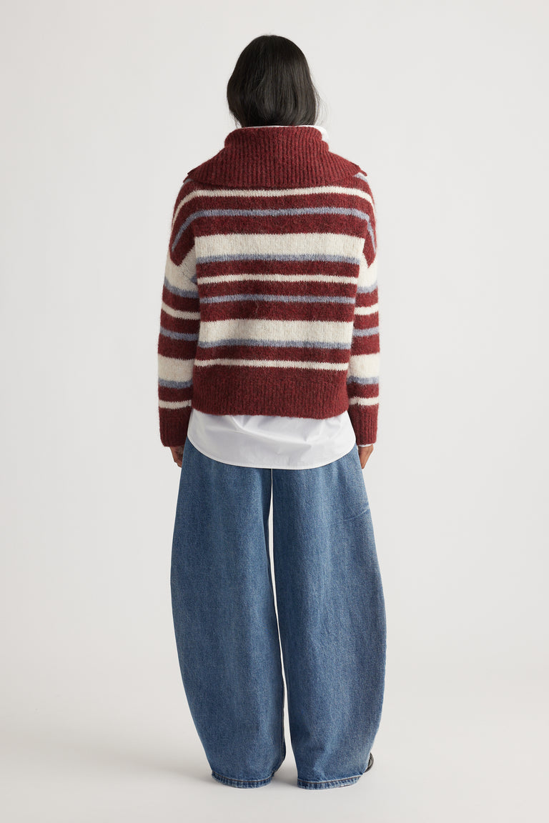 Back view of woman wearing Riley Knit Polo in maroon and cream stripes layered over white shirt with wide-leg denim jeans by DECJUBA Australian brand
