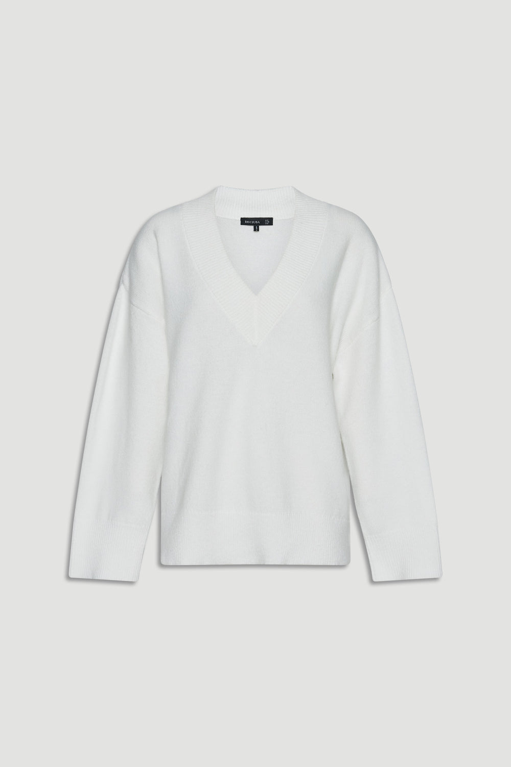 Soft white knit jumper with a relaxed fit and deep V-neck, designed for versatile everyday layering.