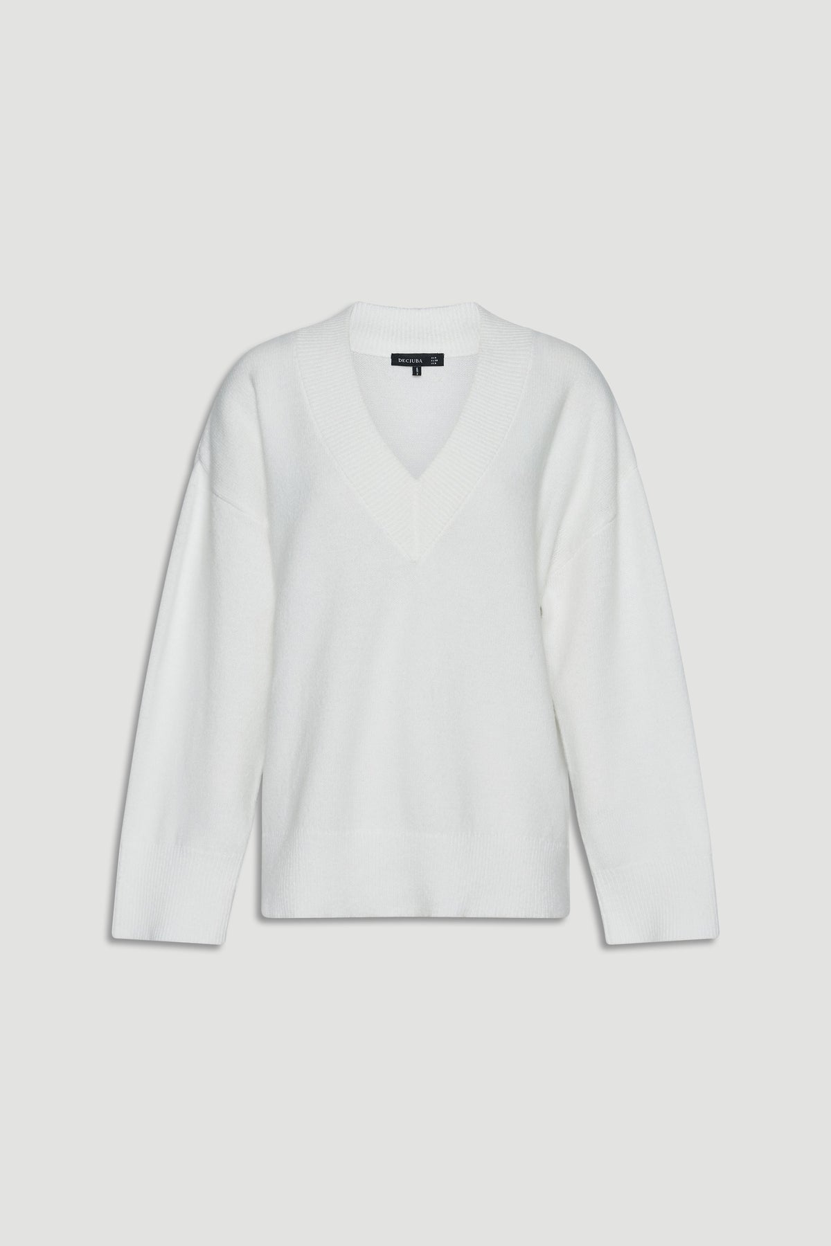 Soft white knit jumper with a relaxed fit and deep V-neck, designed for versatile everyday layering.