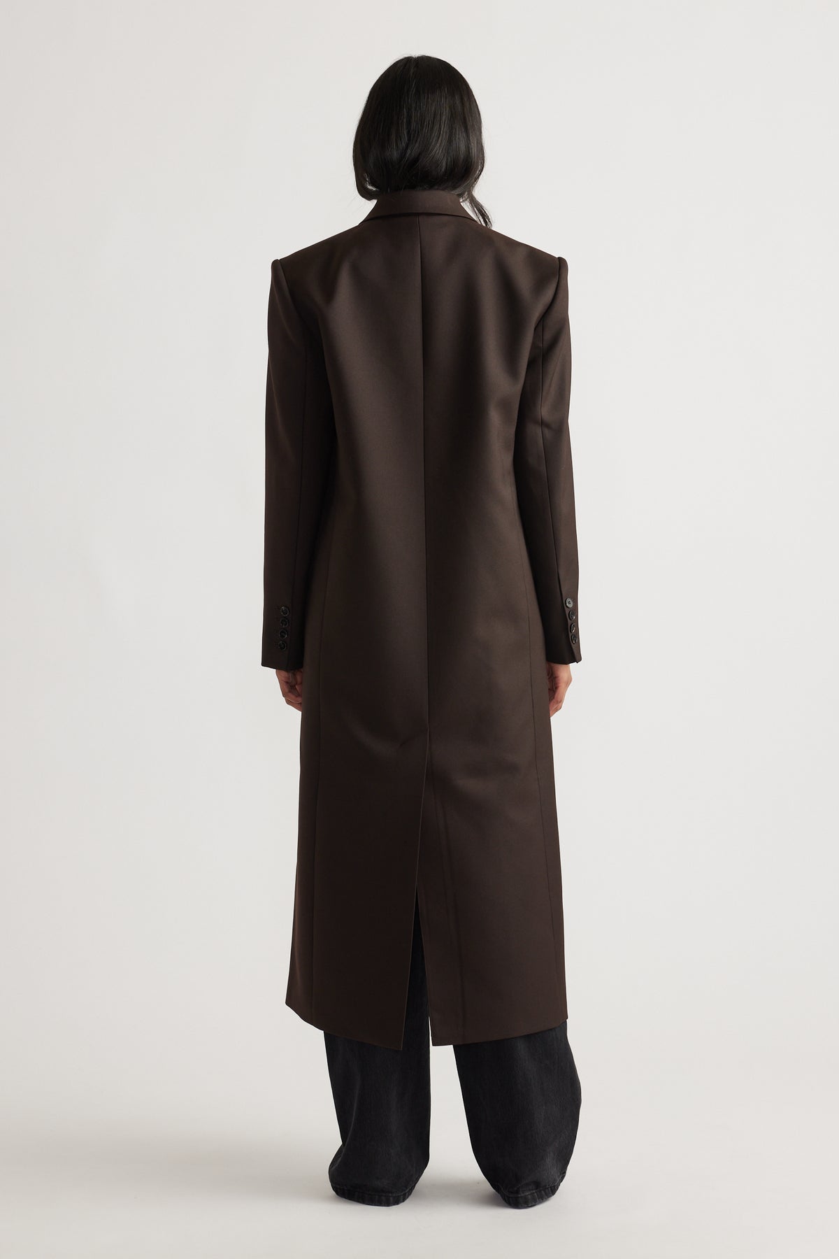 Back view of woman wearing Ella Blazer Coat in rich brown with tailored fit and longline silhouette for timeless elegance.