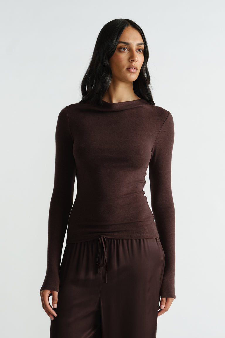 Woman wearing a fitted rich mocha long sleeve top paired with relaxed drawstring pants in matching tones.