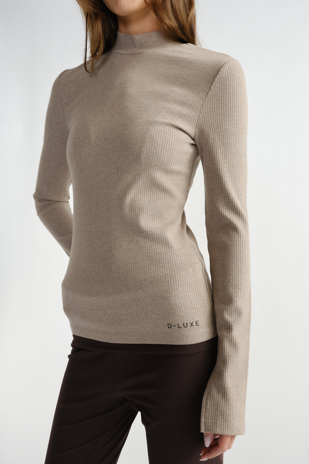 Slim fit ribbed long sleeve top in soft beige with subtle high neckline for a sleek, everyday layer.