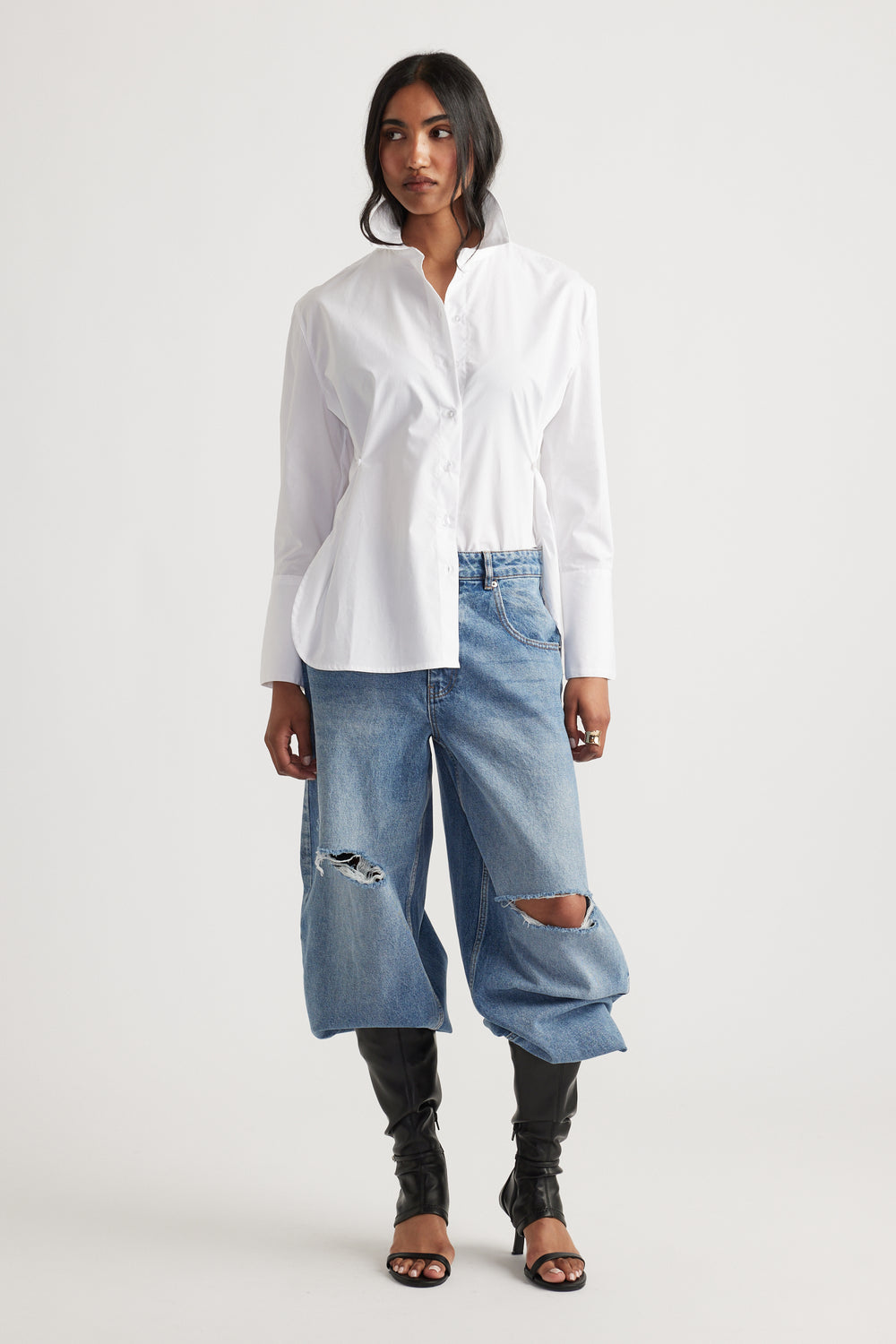 Kristy Side Button Shirt in crisp white cotton with long sleeves styled with oversized ripped denim jeans by DECJUBA Australian fashion brand