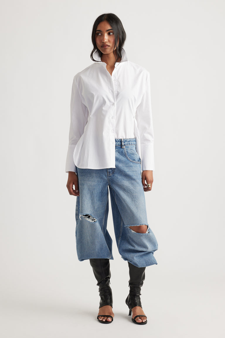 Kristy Side Button Shirt in crisp white cotton with long sleeves styled with oversized ripped denim jeans by DECJUBA Australian fashion brand
