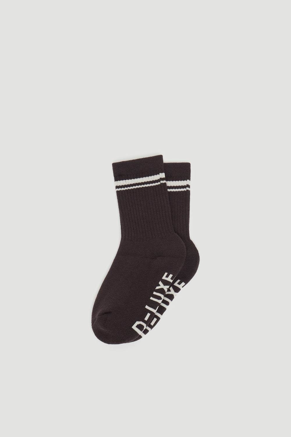 Pair of dark ribbed sports socks featuring white double stripes at the cuff and branded text on the sole.