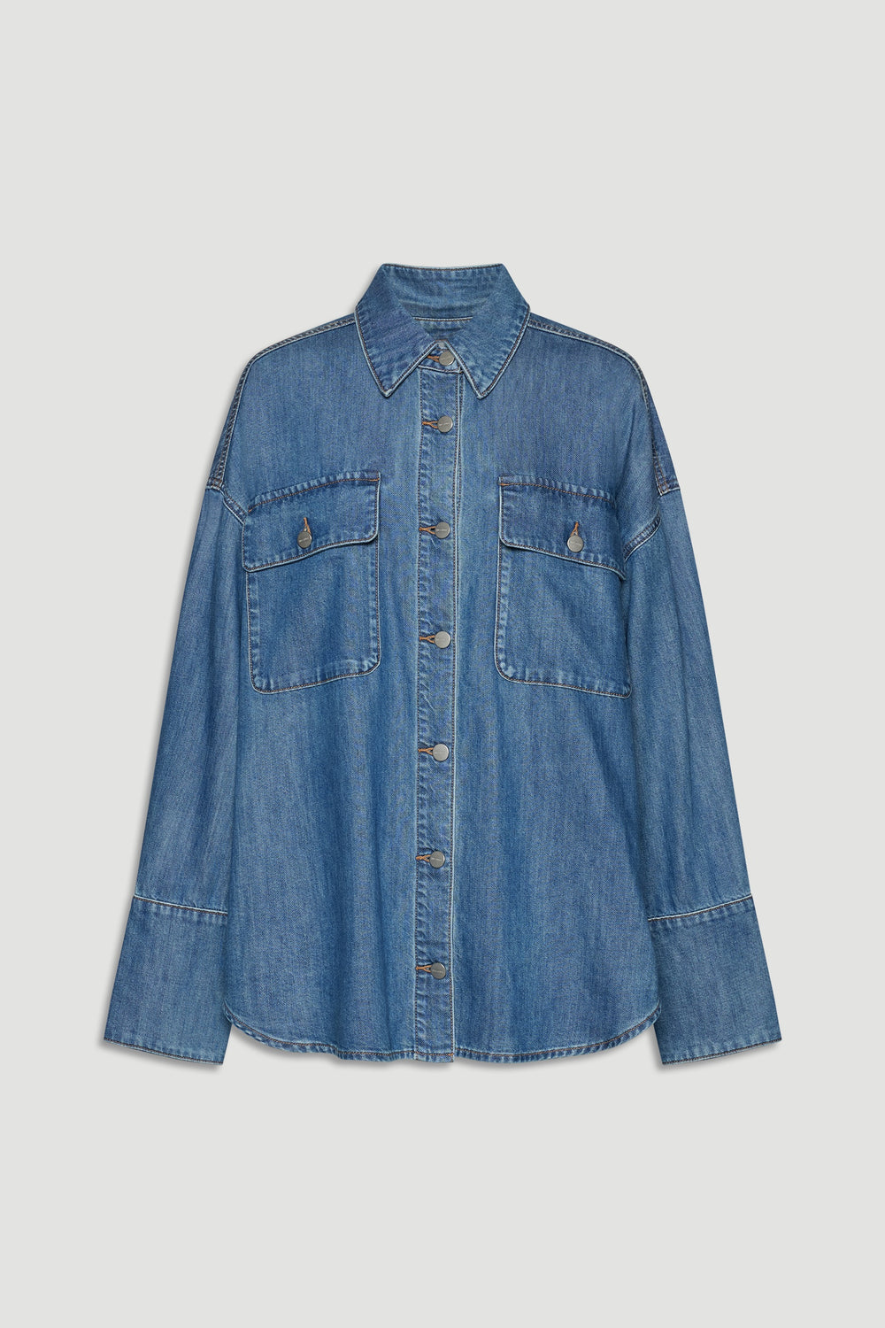 Blue denim shirt with button front, pointed collar, and two large chest pockets for a relaxed, versatile look