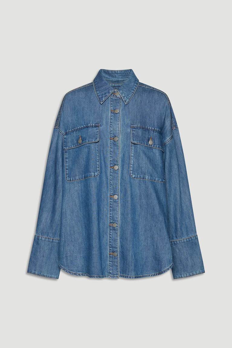 Blue denim shirt with button front, pointed collar, and two large chest pockets for a relaxed, versatile look