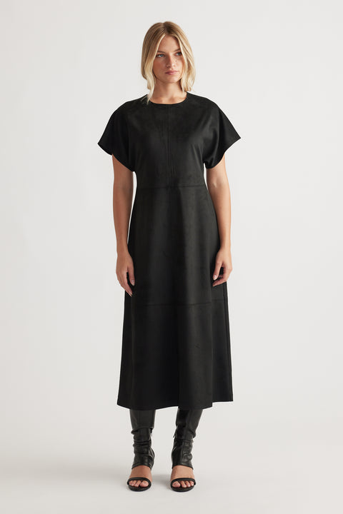 Woman wearing Clara Faux Suede Midi Dress in black with short sleeves and a streamlined silhouette for elegant versatility