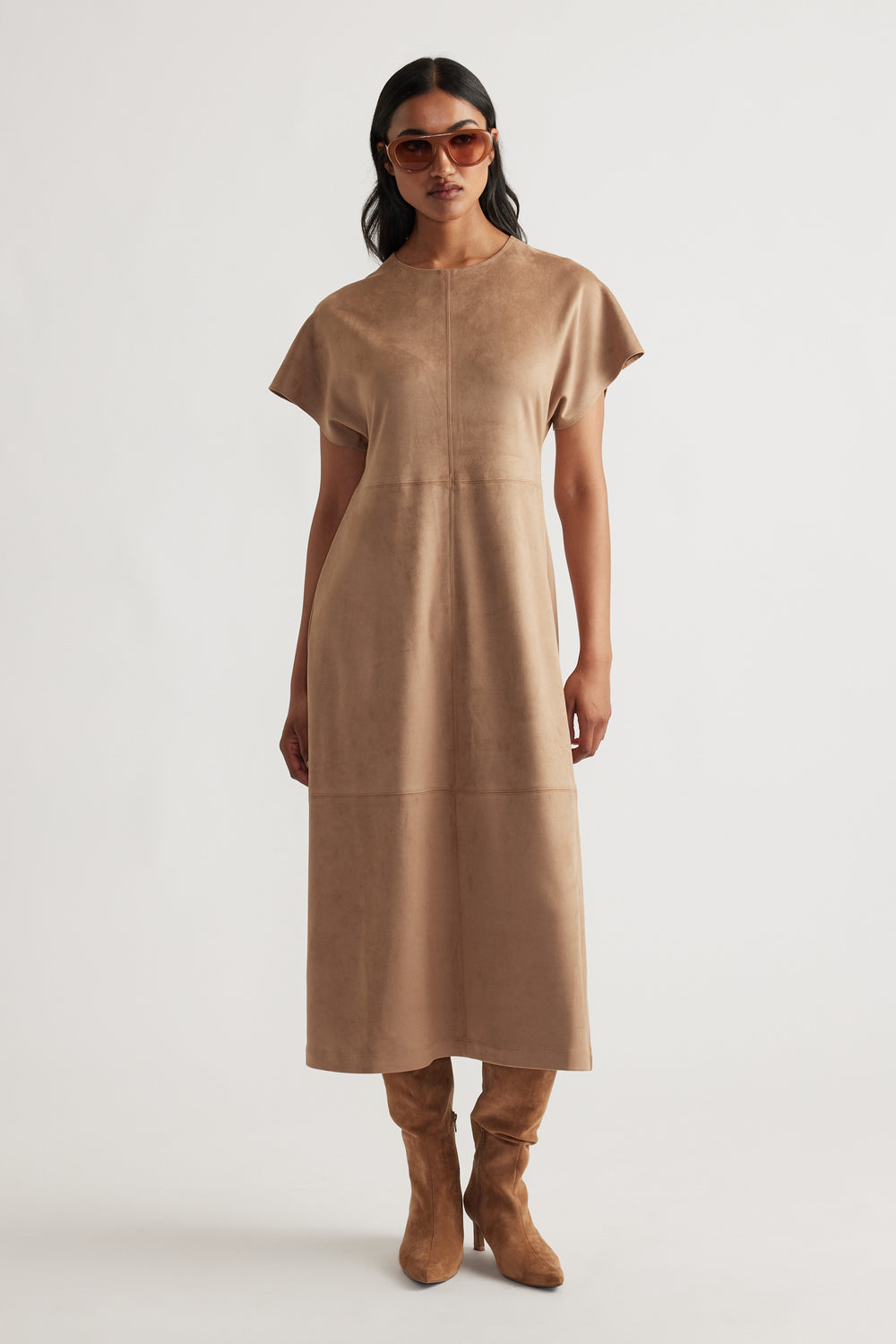 Model wearing Clara Faux Suede Midi Dress in warm tan with short sleeves, paired with matching suede boots and sunglasses