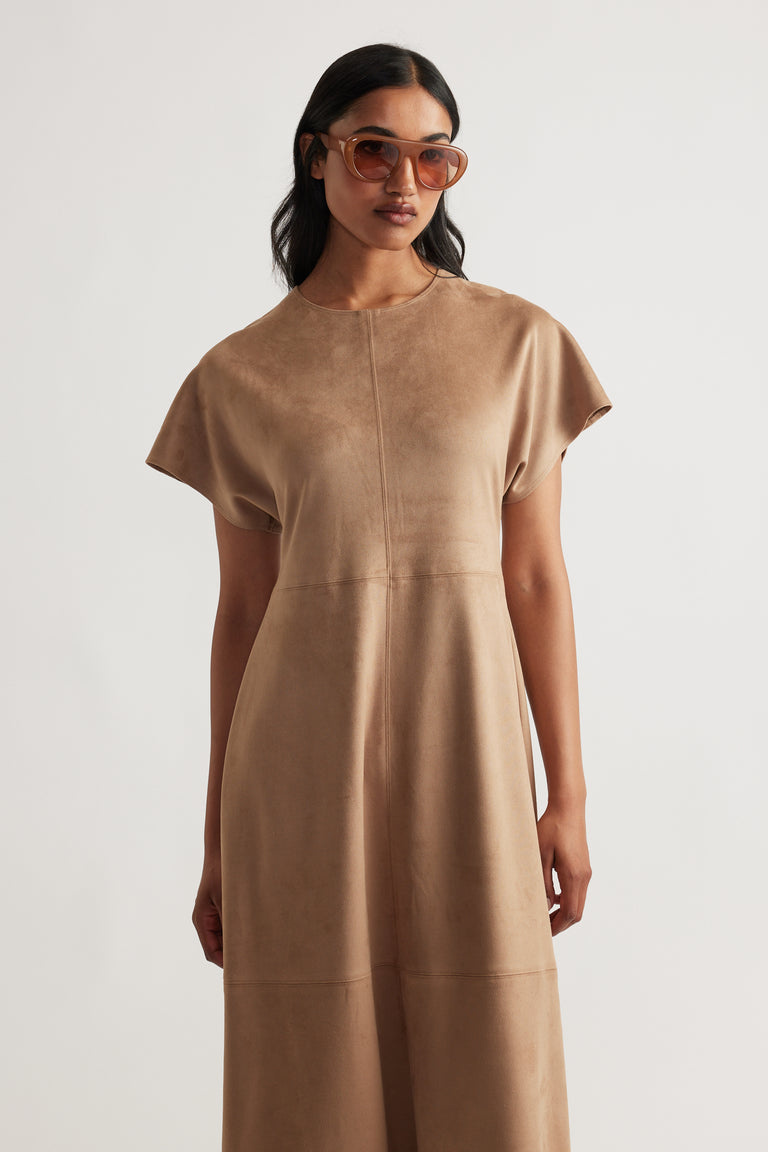 Woman wearing a soft camel Clara Faux Suede Midi Dress with short sleeves and a relaxed fit, styled with tinted sunglasses