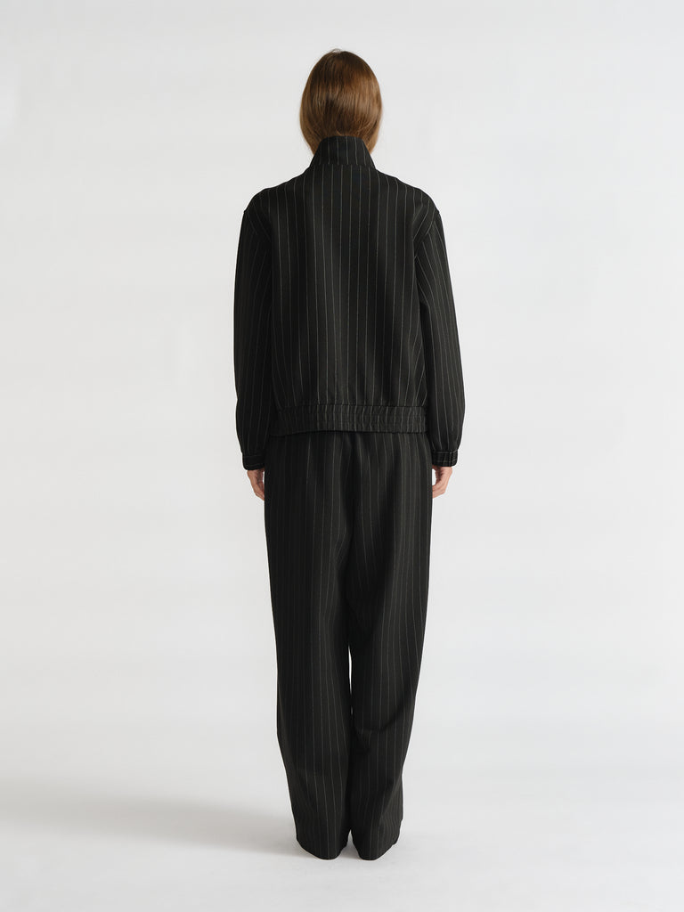 Rear view of woman in relaxed D-Luxe Pinstripe Bomber and matching wide-leg pants for a sleek, timeless look by Decjuba.