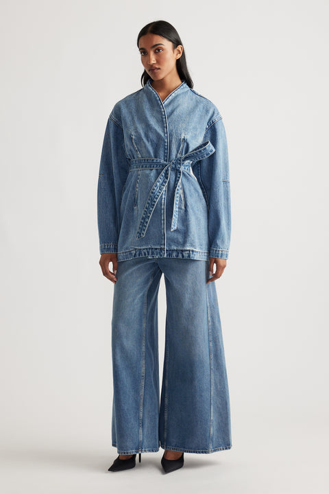 Front view of a woman wearing Kylie Denim Blazer Dress in blue with a belted waist and relaxed fit by DECJUBA