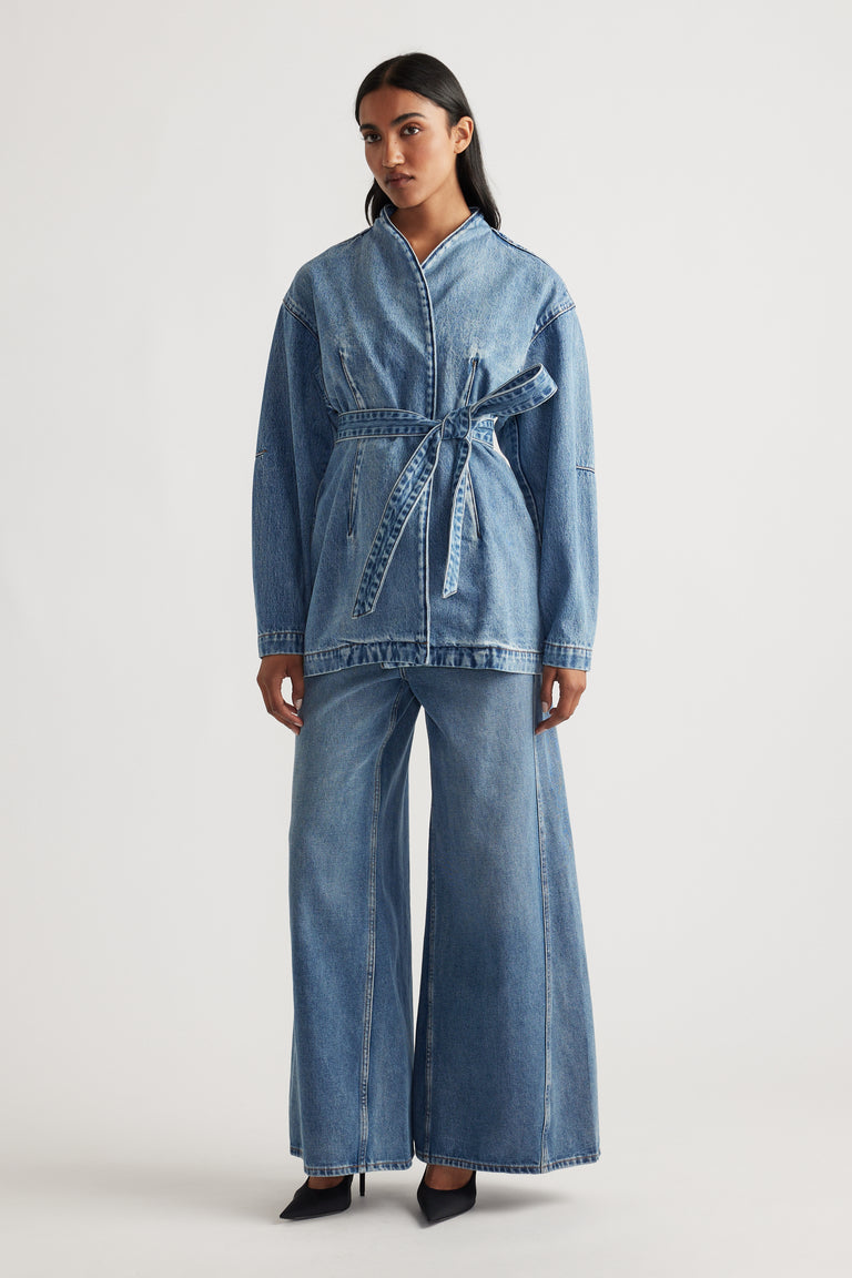Front view of a woman wearing Kylie Denim Blazer Dress in blue with a belted waist and relaxed fit by DECJUBA