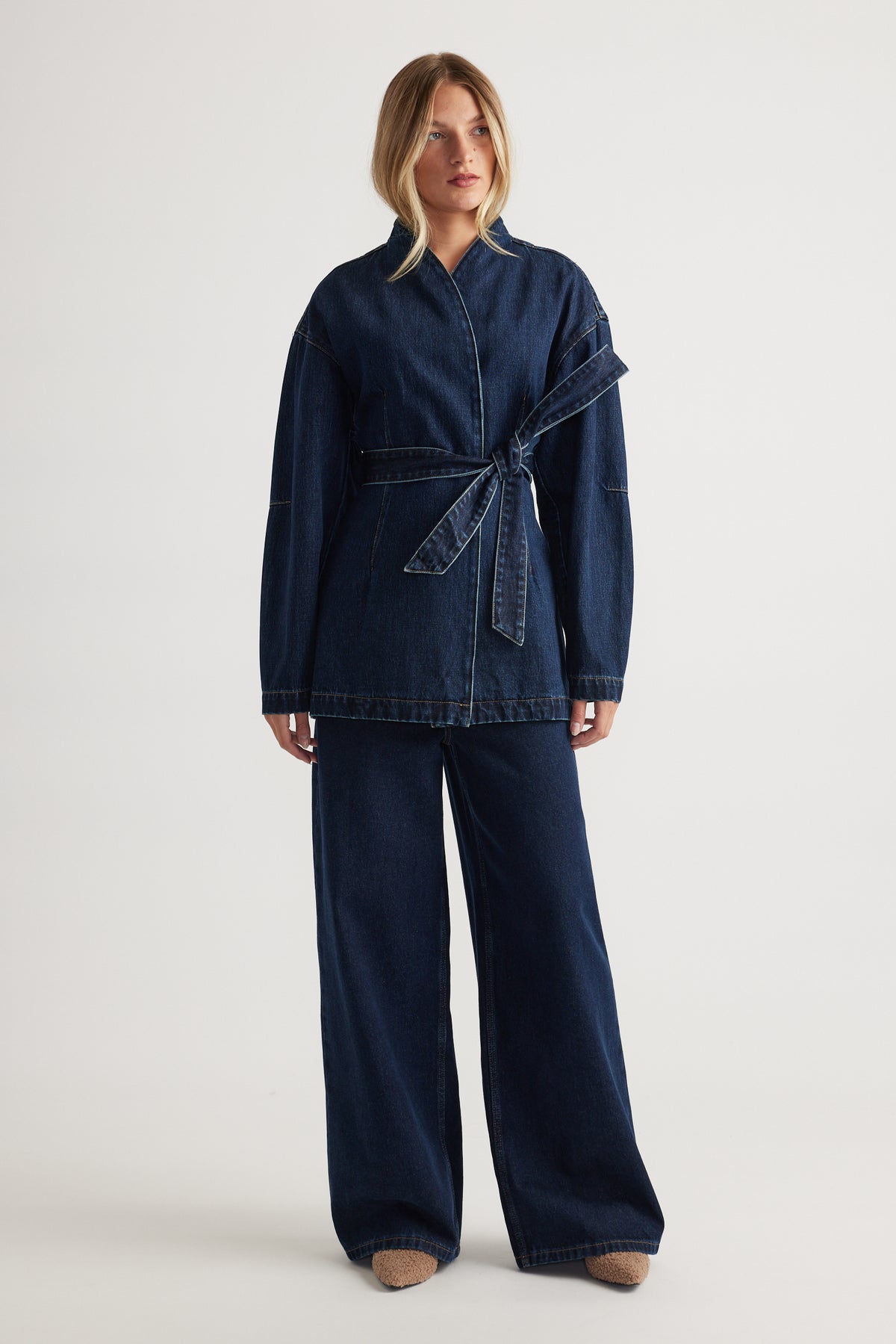 Kylie Denim Blazer Dress styled with a self-tie belt and wide-leg pants in deep indigo by DECJUBA Australian fashion brand
