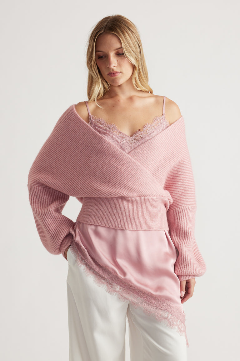 Soft pink crossover knit jumper layered over a lace-trimmed silky cami for an elegant, relaxed look