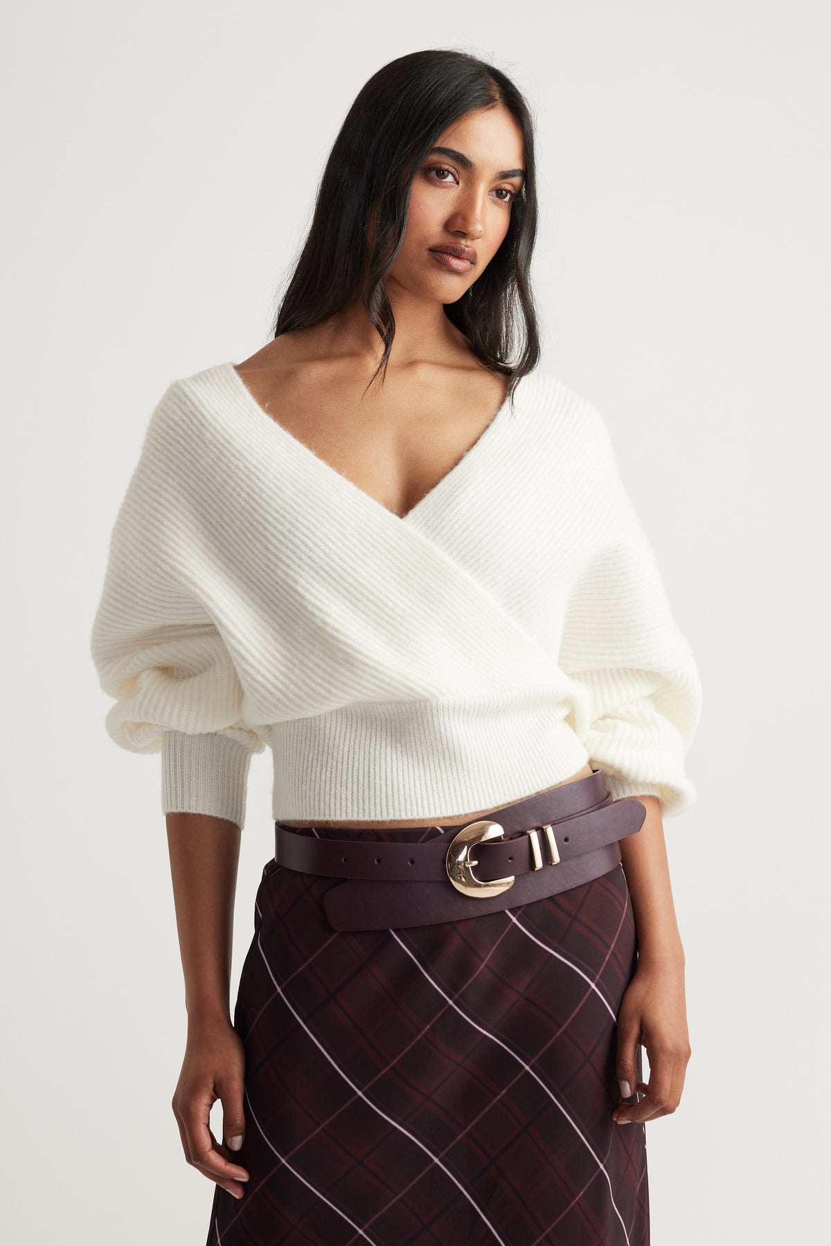 Harper Crossover Jumper in soft white knit with a deep V-neck and relaxed fit styled with plaid skirt by Decjuba Australian brand