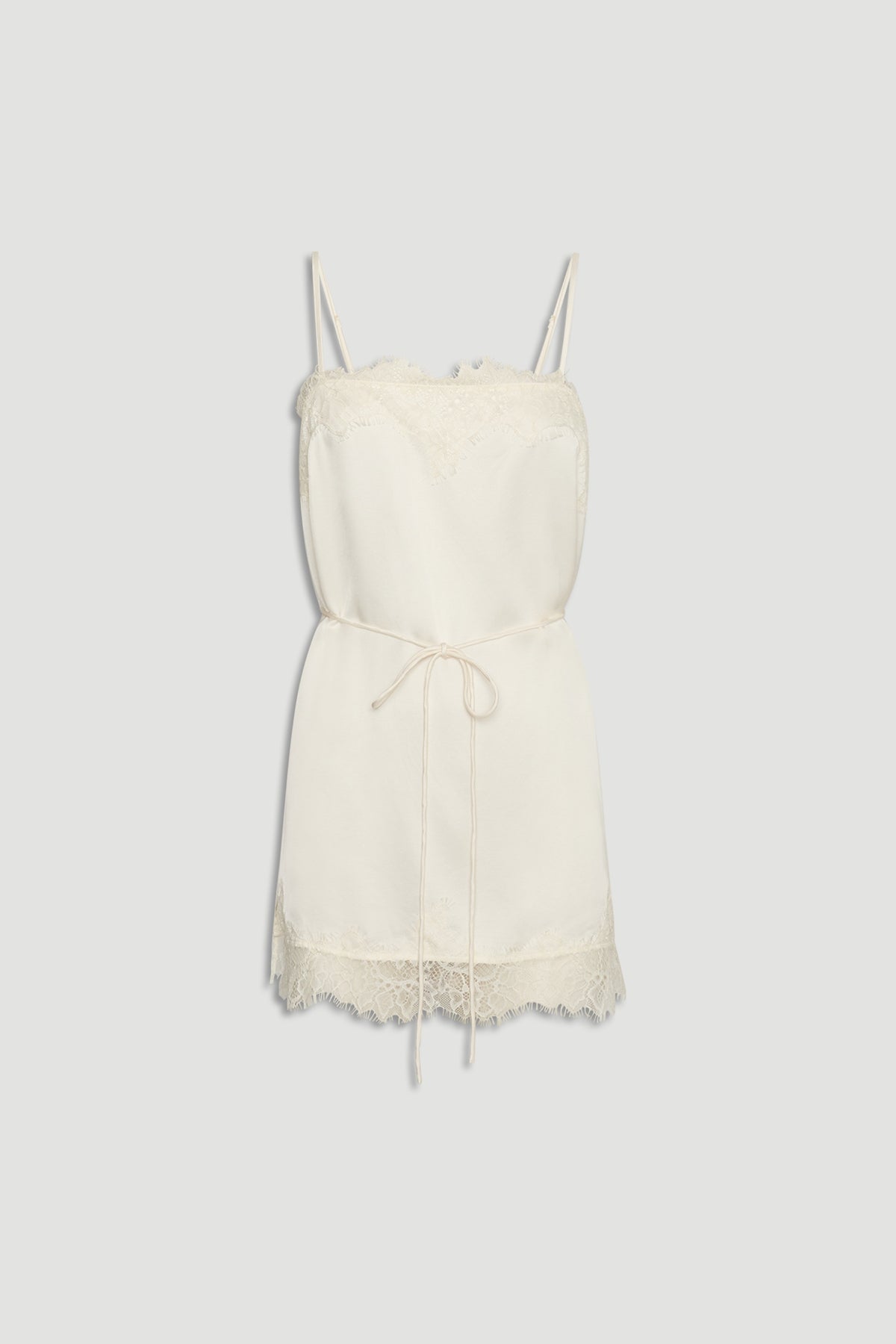 Ivory lace-trimmed slip cami with delicate straps and a thin waist tie for a soft, elegant silhouette