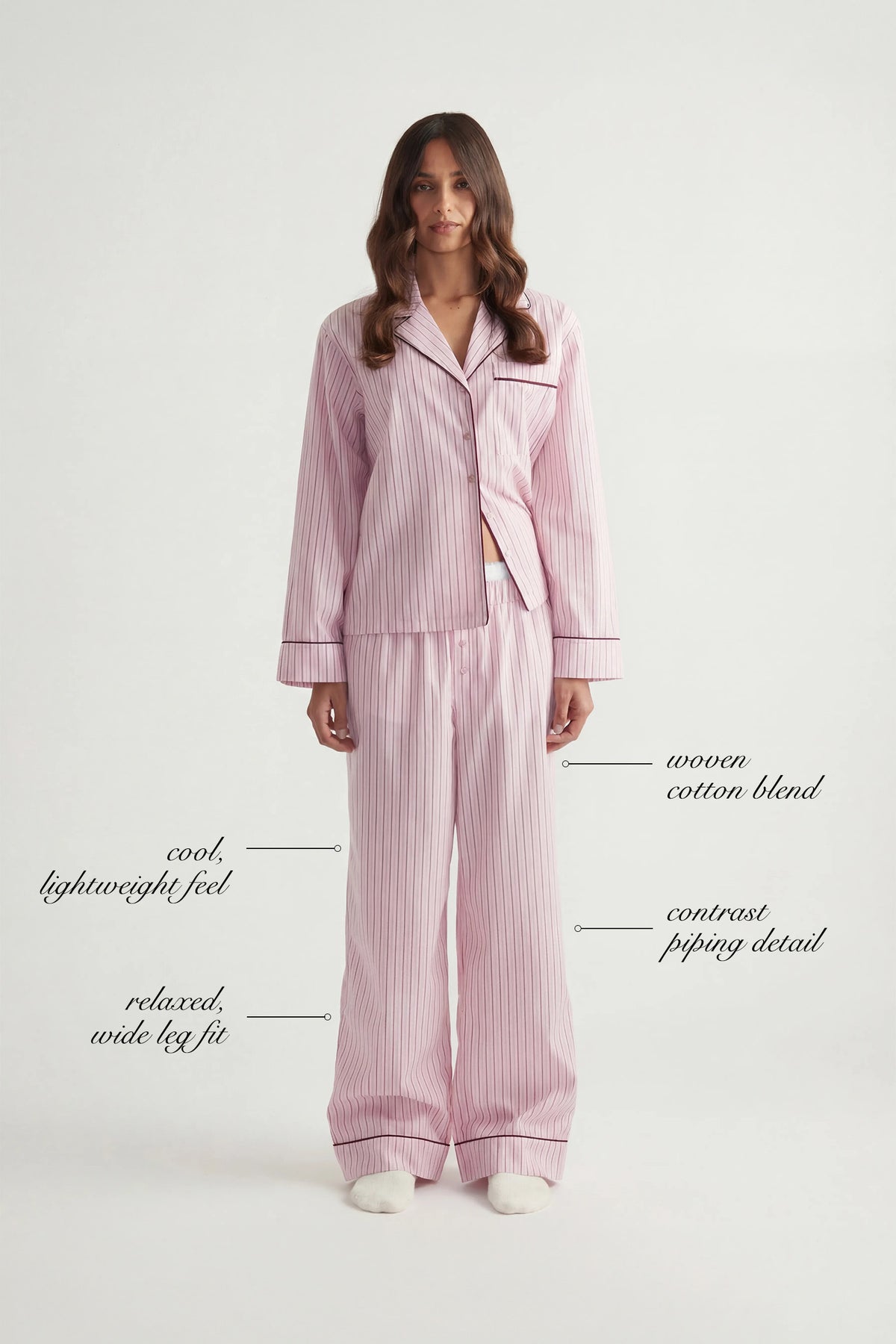 Woman wearing pink striped woven cotton blend wide leg pants with contrast piping and relaxed fit