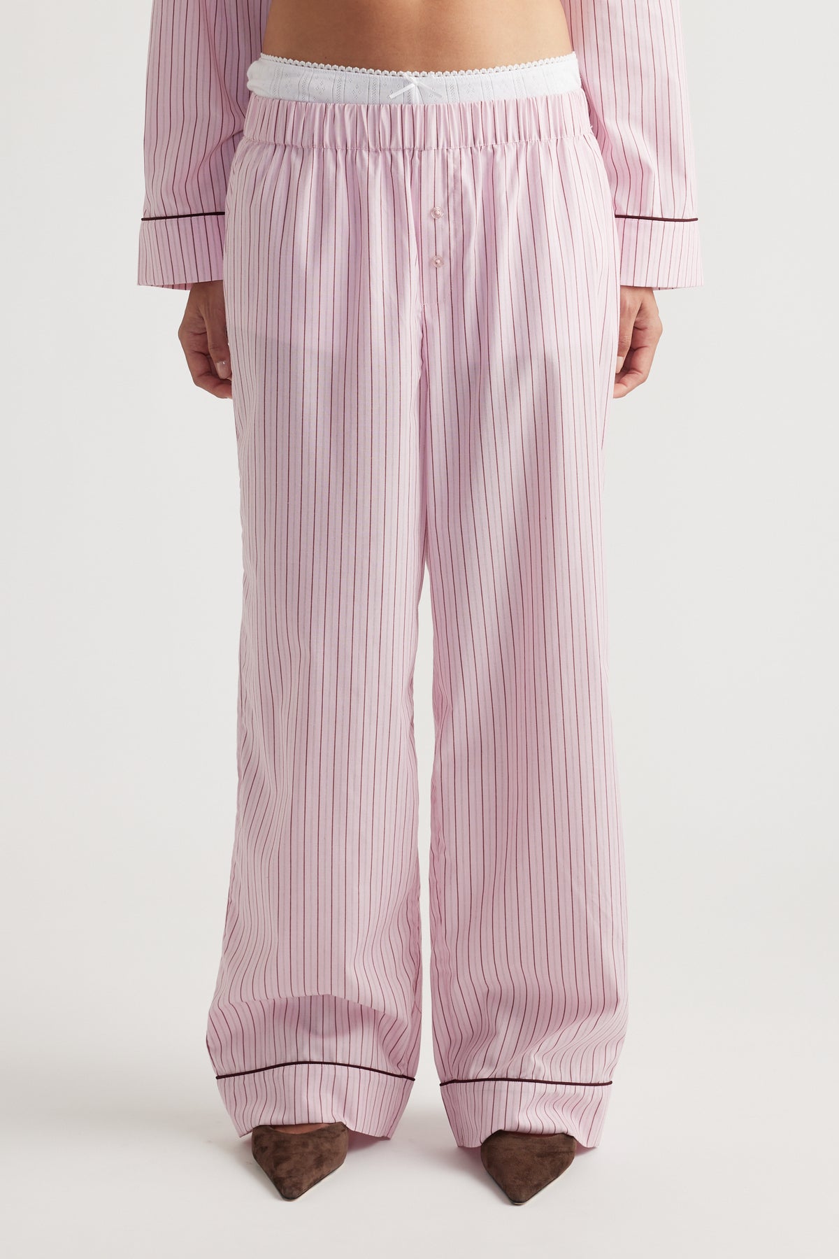 Front view of soft pink woven wide leg pants with vertical stripes and elastic waistband for relaxed comfort fit