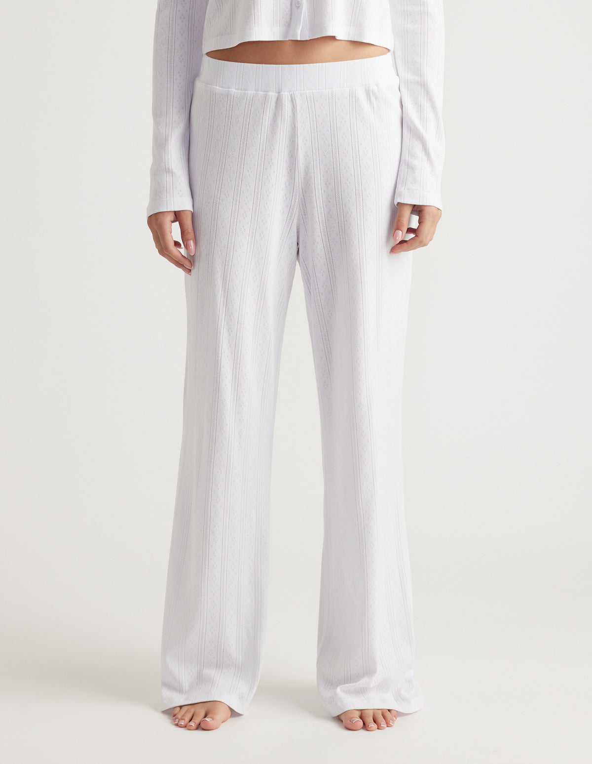 White wide leg pointelle knit pants with elastic waistband for a relaxed and breathable loungewear style