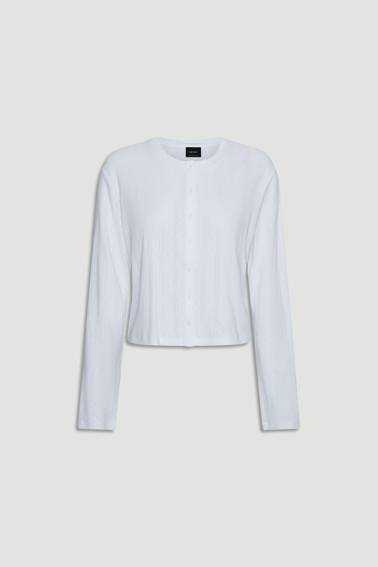 White lightweight pointelle knit long sleeve top with button front and relaxed fit for casual layering