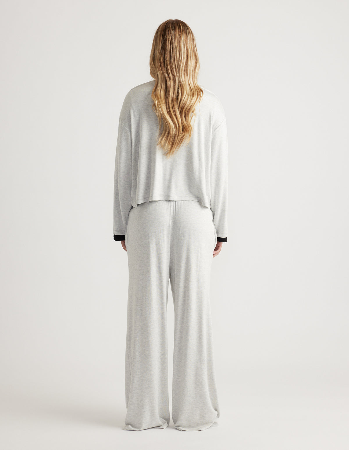 Back view of relaxed fit light grey sleep jersey long sleeve top and matching wide-leg pants in soft fabric